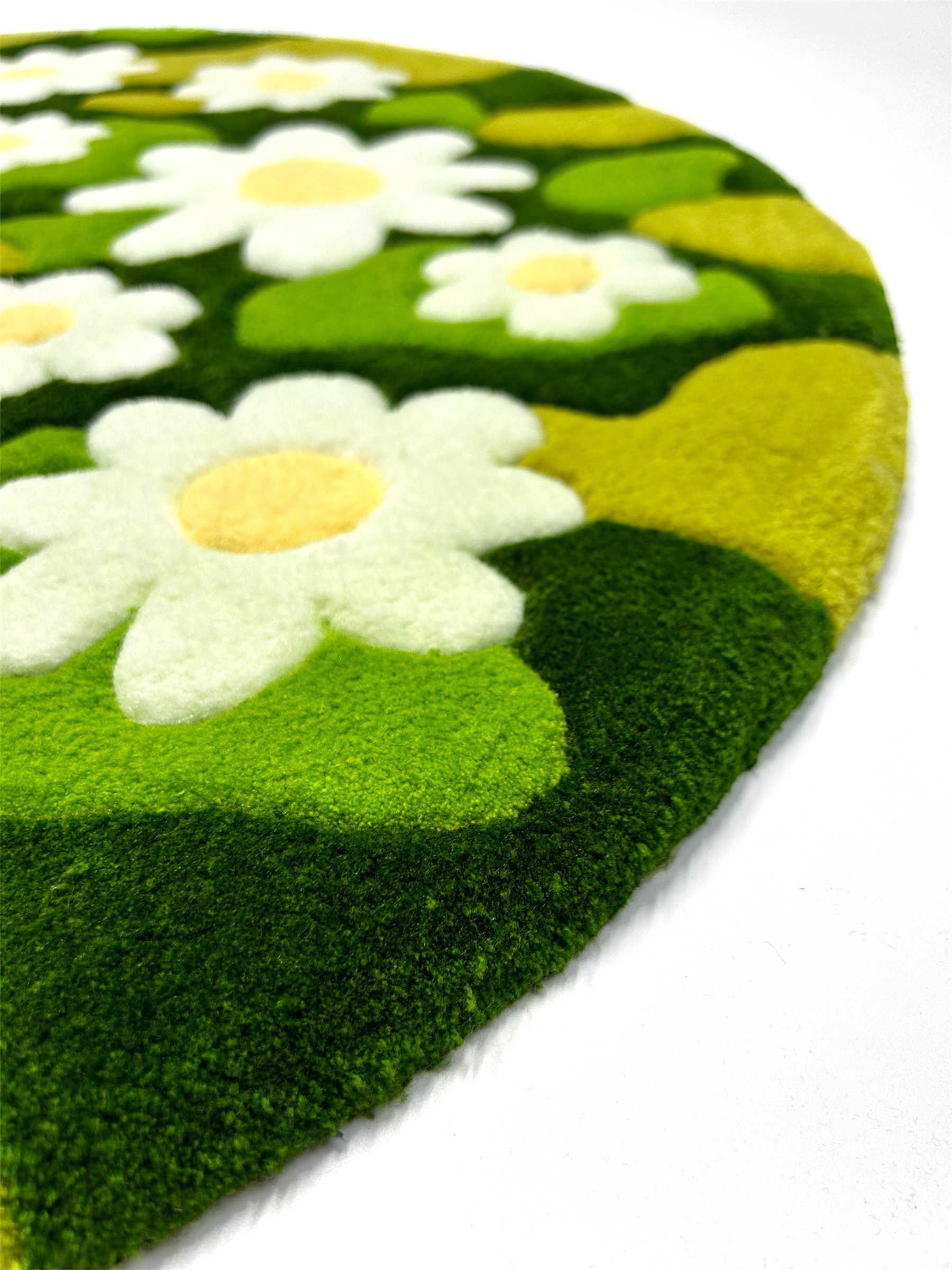 Round handmade green moss rug with chamomile flower pattern side view