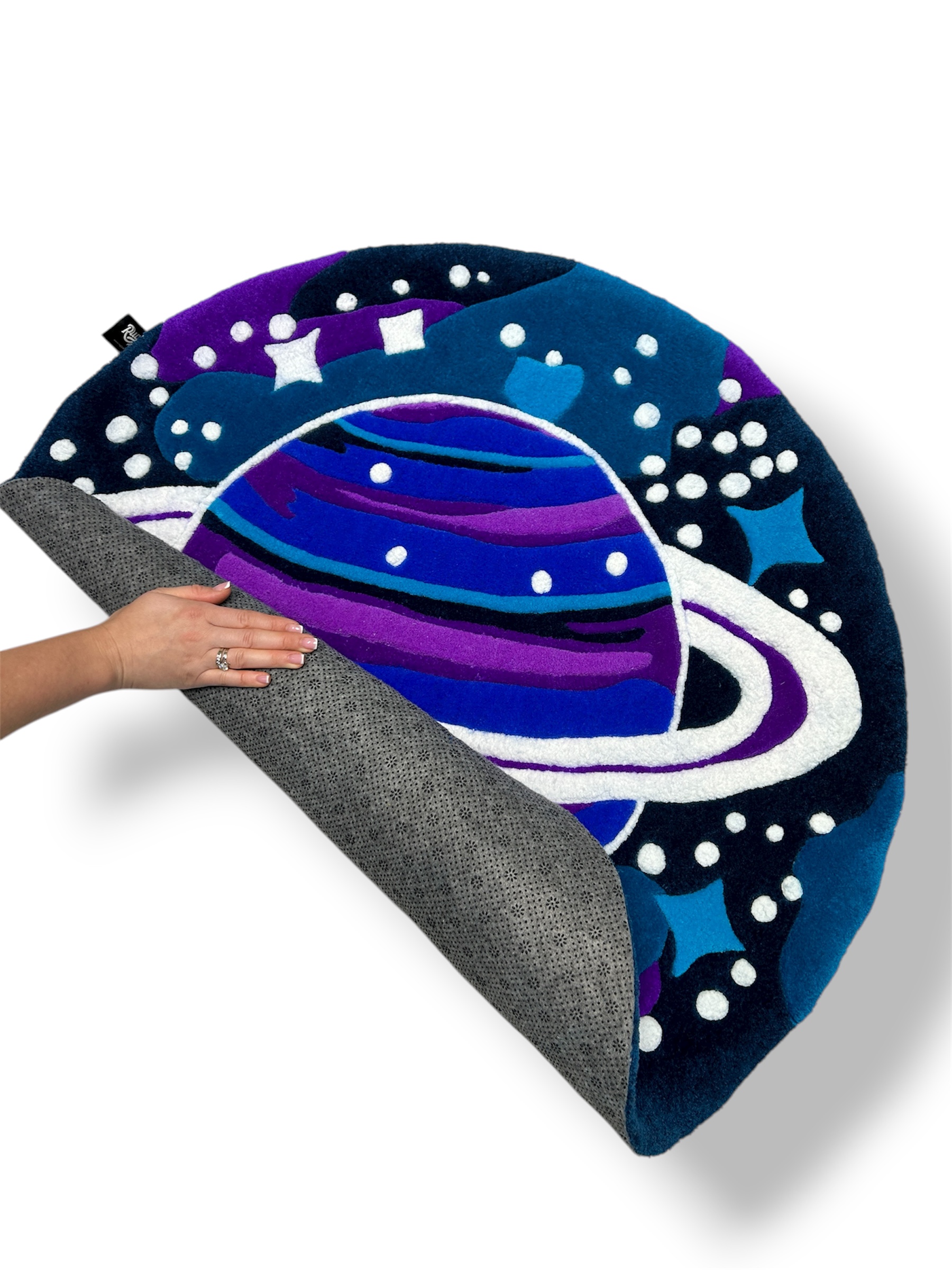 Anti-slip backing of handmade tufted rug Cosmos, safe for all floor types and finished with neat stitching.